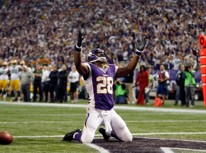 Vikings running back Peterson celebrates touchdown during NFL football game against Packers in Minneapolis
